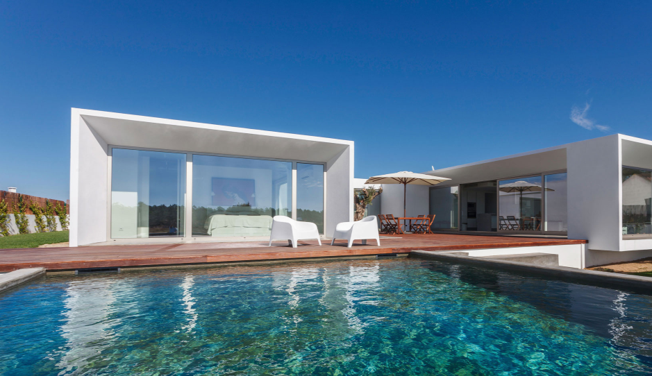 a swimming pool with a deck and chairs with no residential window tint.